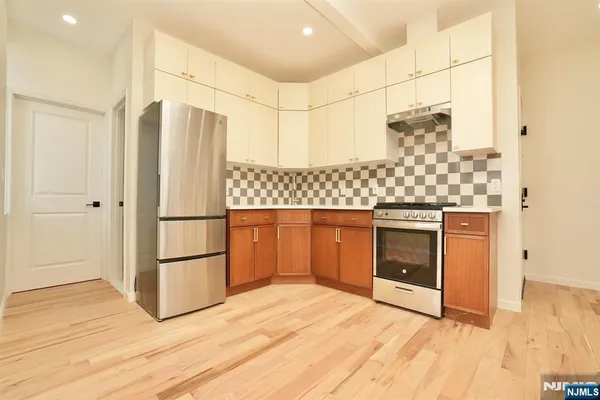 a kitchen with granite countertop a refrigerator and a stove
