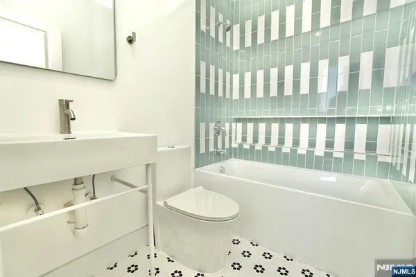 a bathroom with a sink a toilet and a bathtub