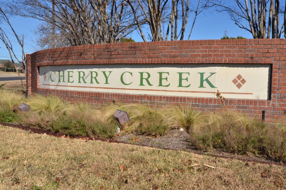 9405 Lightwood Loop Austin, TX 78748 - Photo 2 of 24 Cherry Creek community entrance sign featuring a curved brick facade