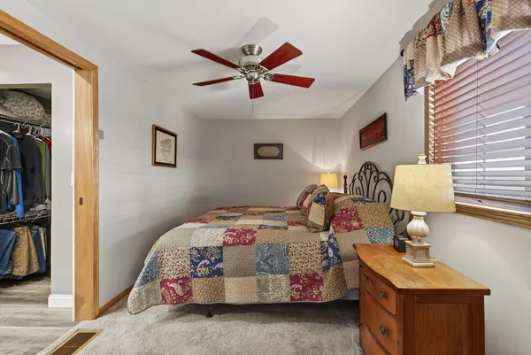 a bedroom with bed and a window