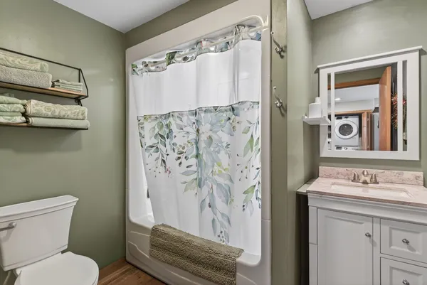 a bathroom with a sink toilet and shower