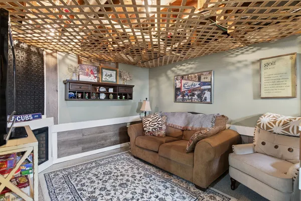 a living room with furniture and paintings on the wall