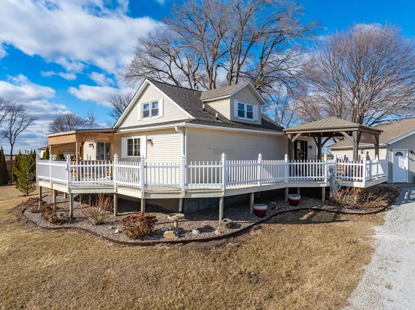 a front view of a house with a yard outdoor seating and garage