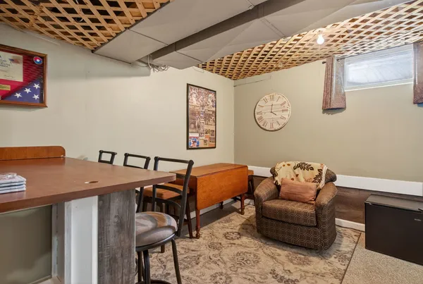 a room with furniture and paintings on the wall