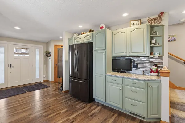 a kitchen with stainless steel appliances a refrigerator sink and cabinets
