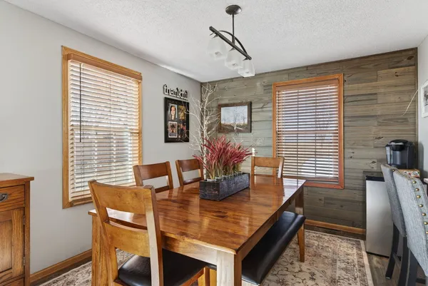 a dining room with furniture and window