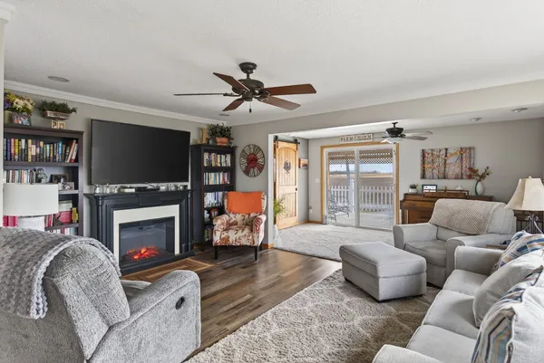 a living room with furniture a fireplace and a flat screen tv