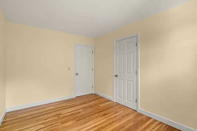 a view of a room with wooden floor and white wall