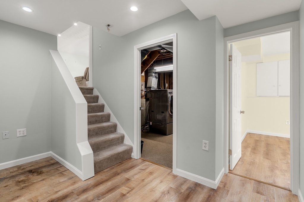 56 Paul Road Holliston, MA 01746 - Photo 17 of 33 a view of hallway with stairs and wooden floor