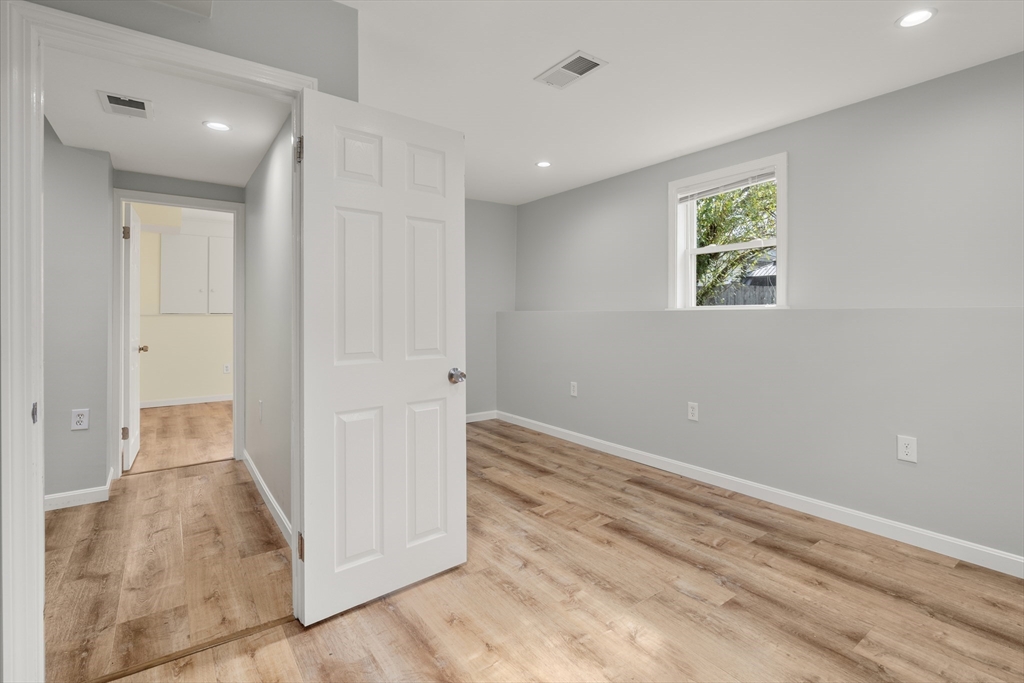 56 Paul Road Holliston, MA 01746 - Photo 18 of 33 an empty room with wooden floor and windows