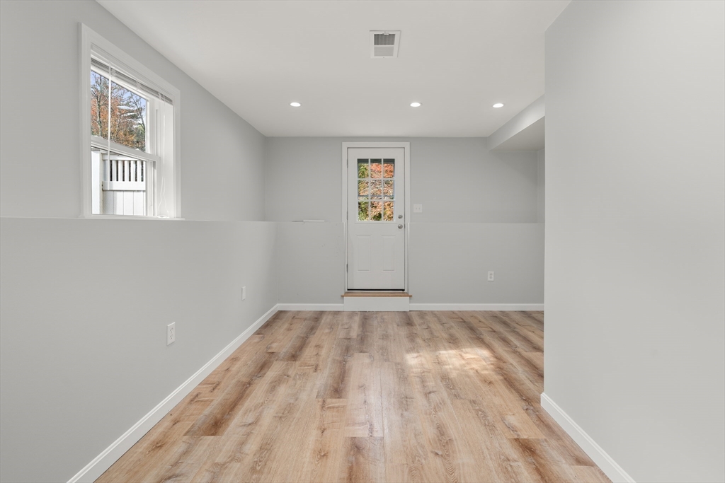 56 Paul Road Holliston, MA 01746 - Photo 21 of 33 an empty room with wooden floor and windows
