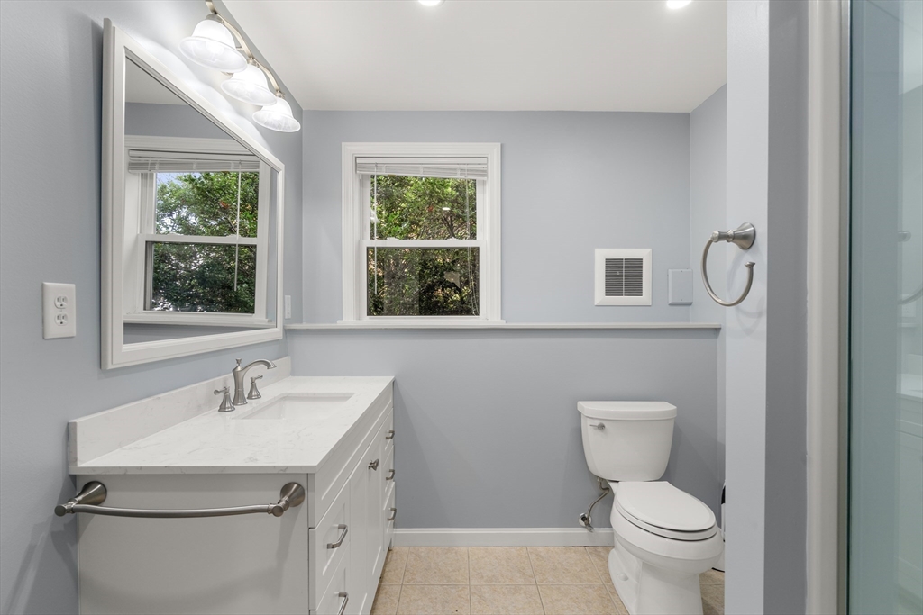 56 Paul Road Holliston, MA 01746 - Photo 22 of 33 a bathroom with a toilet a sink a mirror and a window