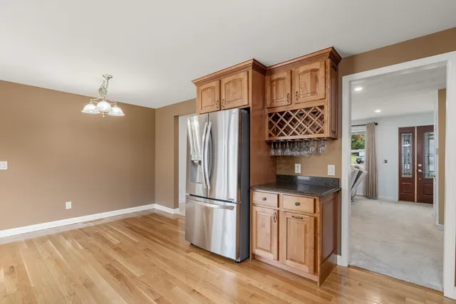 a kitchen with stainless steel appliances granite countertop a refrigerator and a stove top oven
