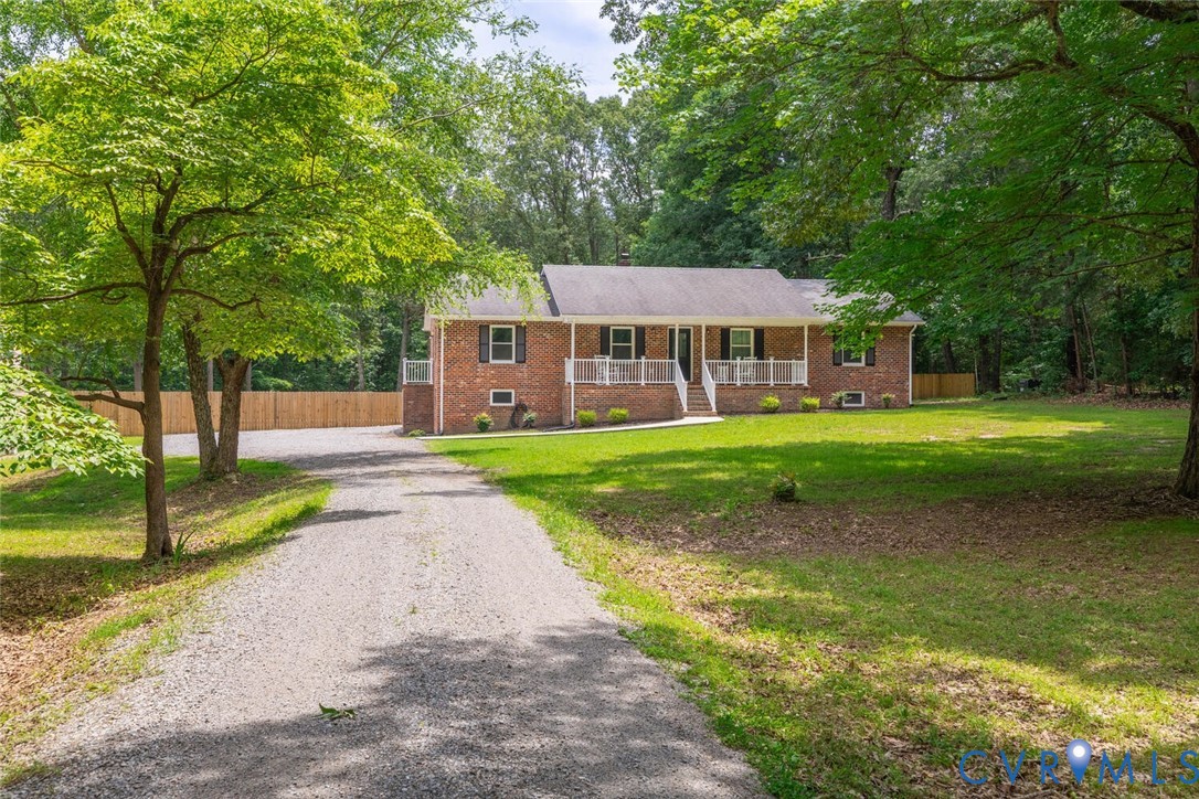 12397 New Market Mill Road Beaverdam, VA 23015 - Photo 38 of 44 a front view of a house with a yard and garage
