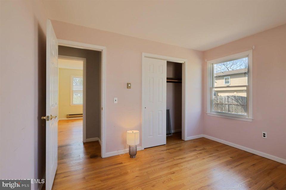 229 Point Pleasant Avenue Bayville, NJ 08721 - Photo 20 of 27 a view of an empty room with wooden floor and a window