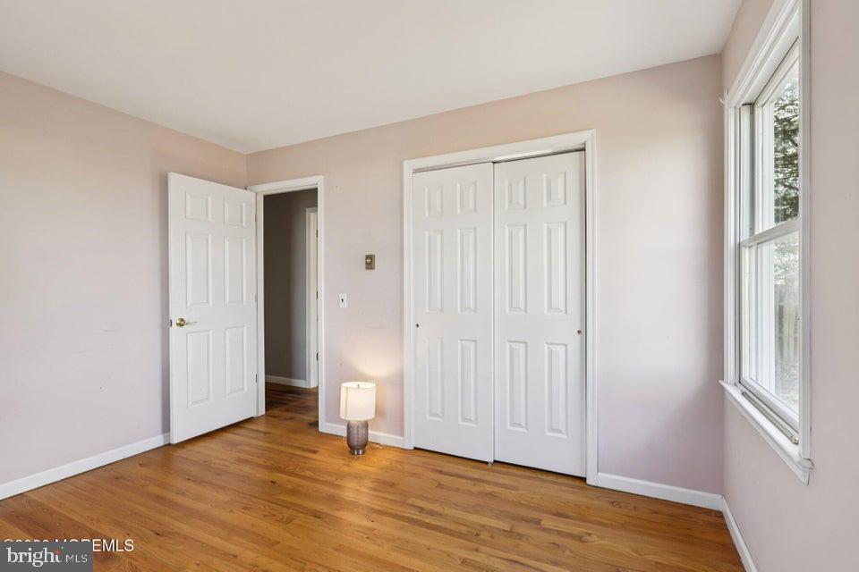 229 Point Pleasant Avenue Bayville, NJ 08721 - Photo 21 of 27 a view of an empty room with wooden floor and a window