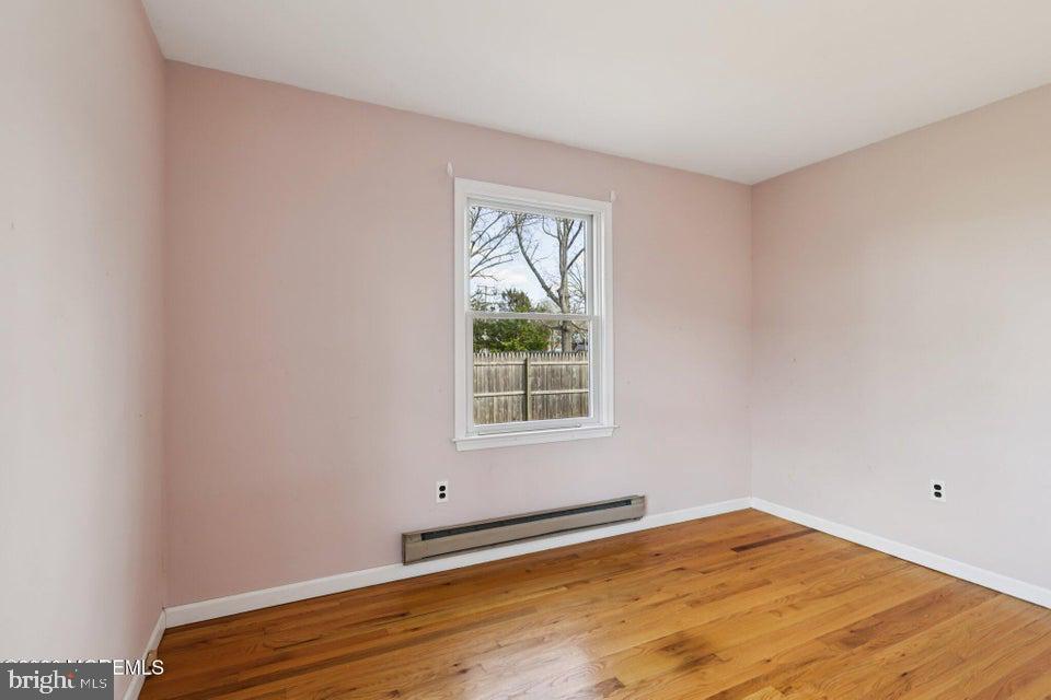 229 Point Pleasant Avenue Bayville, NJ 08721 - Photo 22 of 27 a view of an empty room with wooden floor and a window