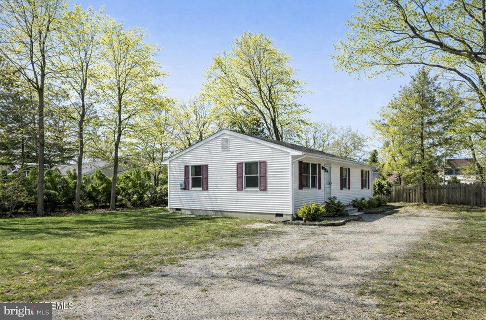229 Point Pleasant Avenue Bayville, NJ 08721 - Photo 27 of 27 a white house that has a tree in front of it