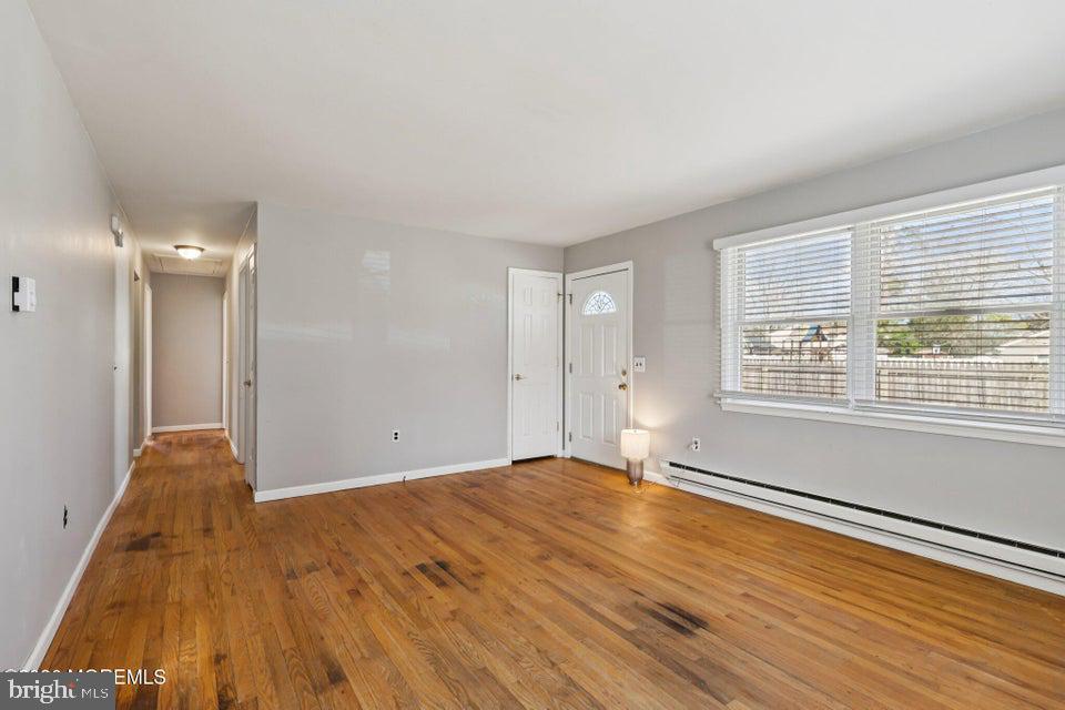 229 Point Pleasant Avenue Bayville, NJ 08721 - Photo 3 of 27 a view of an empty room with wooden floor and a window