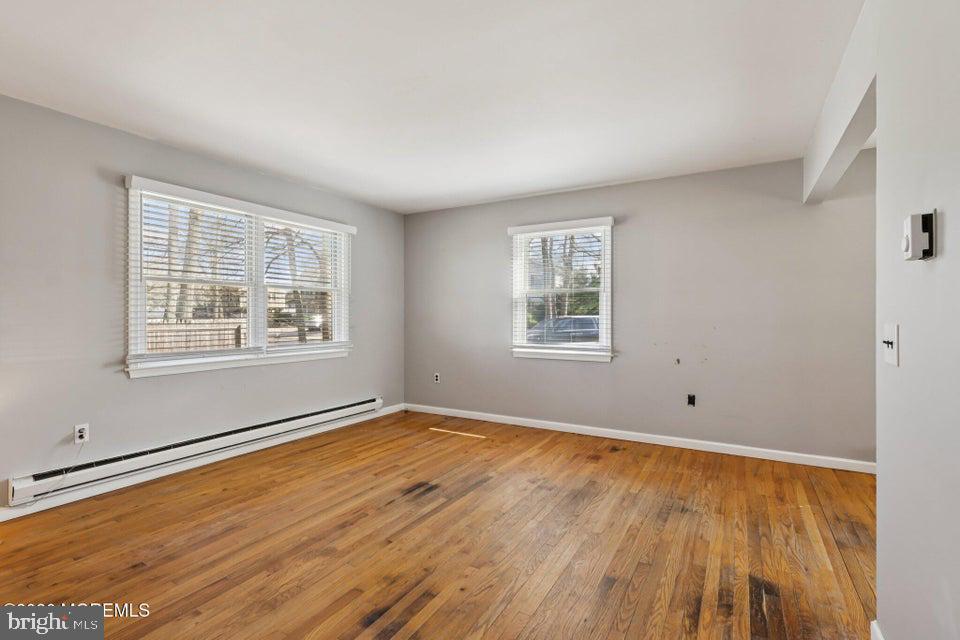 229 Point Pleasant Avenue Bayville, NJ 08721 - Photo 5 of 27 a view of an empty room with wooden floor and a window
