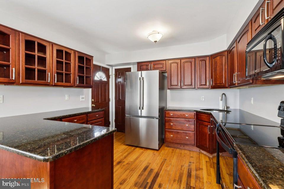 229 Point Pleasant Avenue Bayville, NJ 08721 - Photo 7 of 27 a kitchen with stainless steel appliances granite countertop a refrigerator a stove and a sink with wooden cabinets