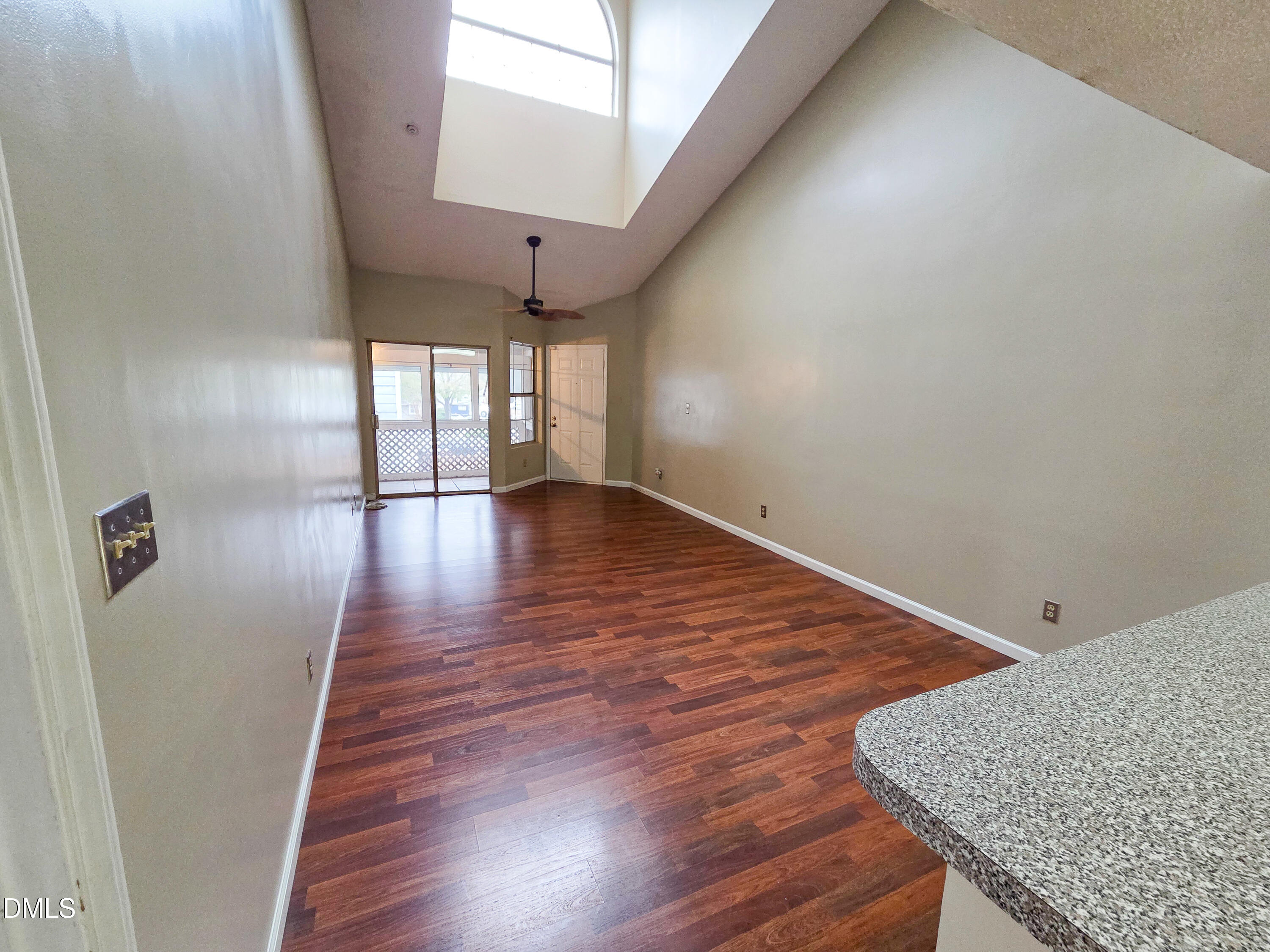 3810 Grey Harbor Drive, Unit 307 Raleigh, NC 27616 - Photo 3 of 25 a view of an empty room with wooden floor and a window