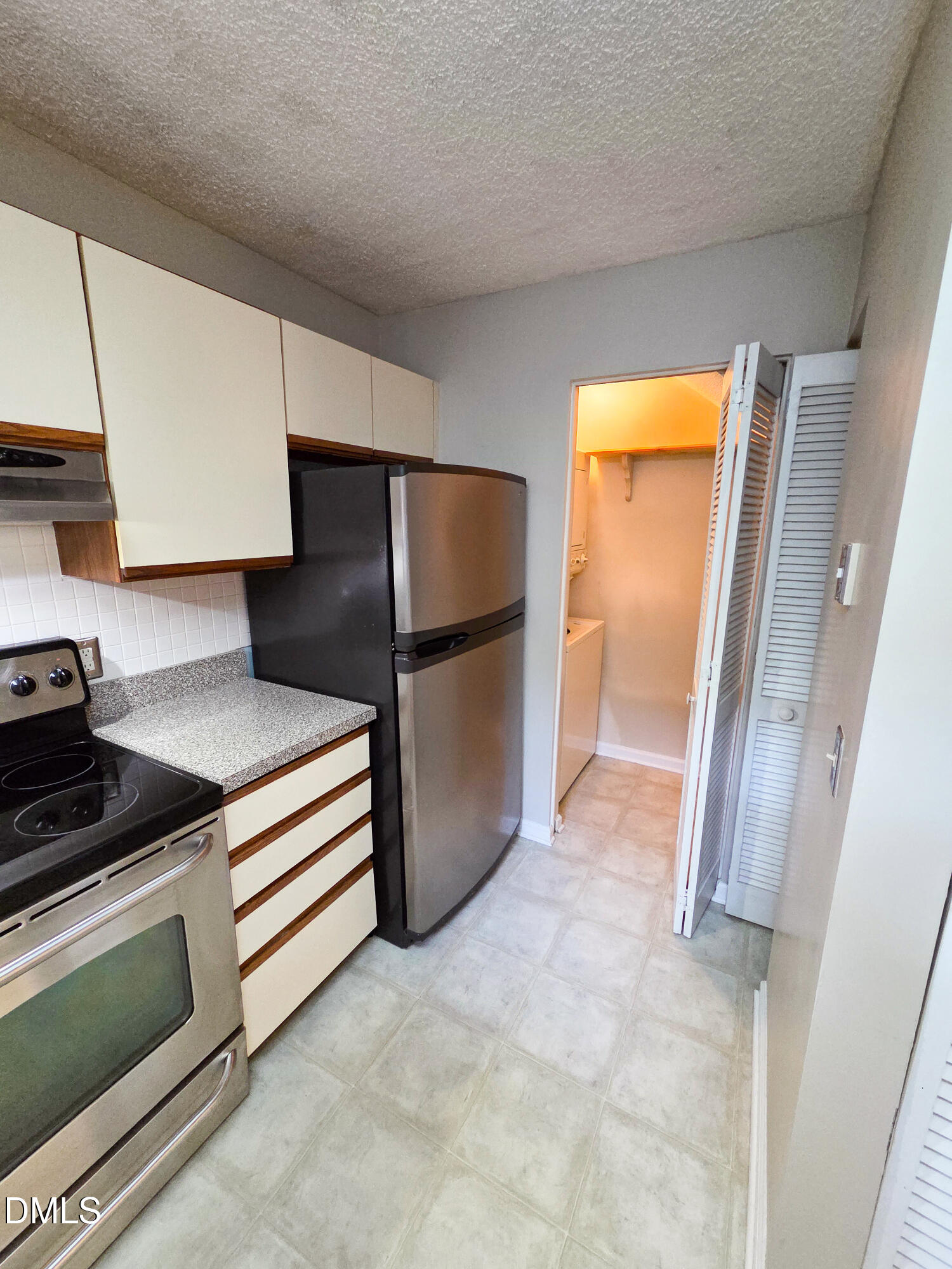 3810 Grey Harbor Drive, Unit 307 Raleigh, NC 27616 - Photo 8 of 25 a kitchen with a refrigerator and a stove