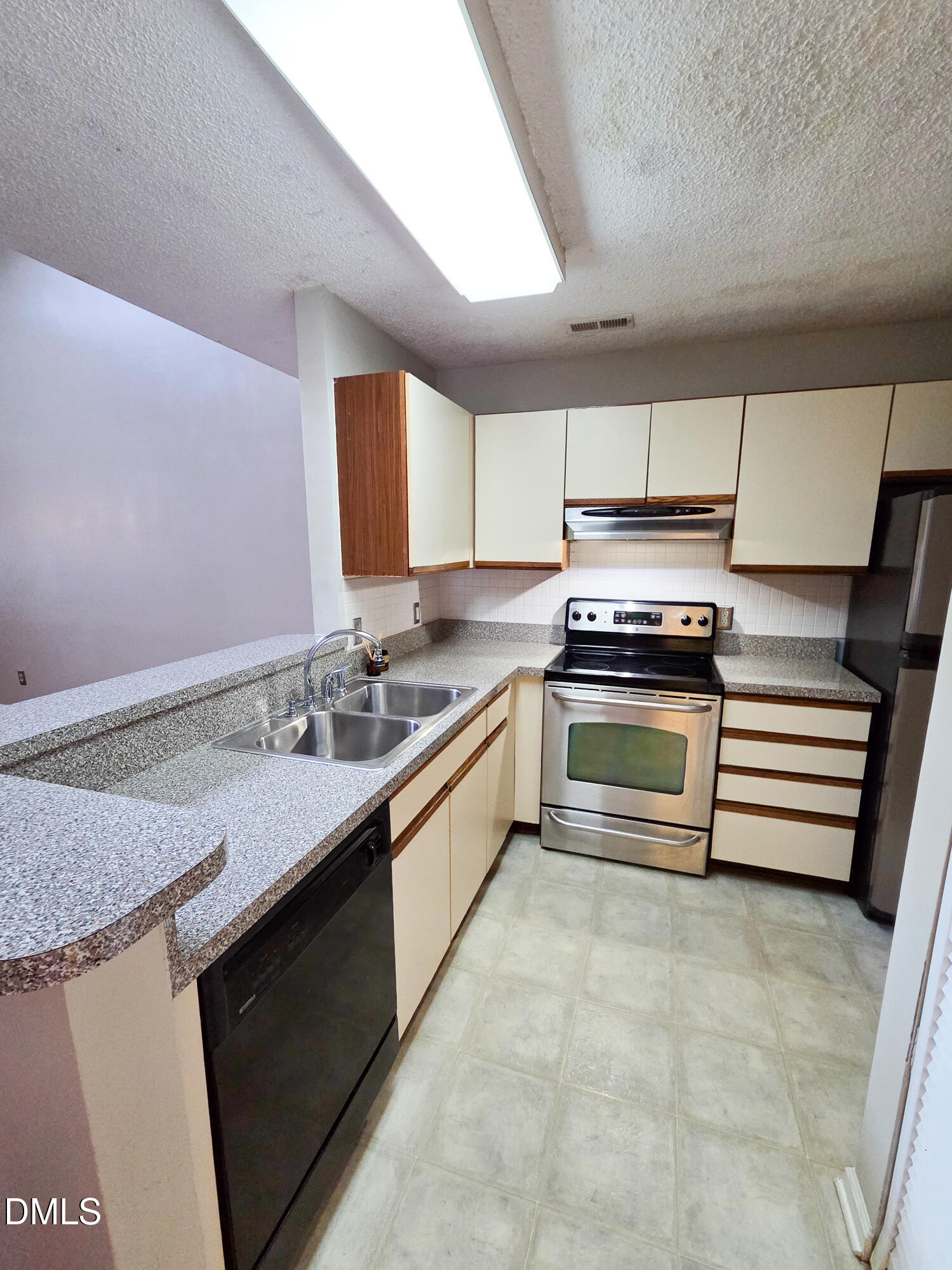 3810 Grey Harbor Drive, Unit 307 Raleigh, NC 27616 - Photo 9 of 25 a kitchen with a stove sink and cabinets
