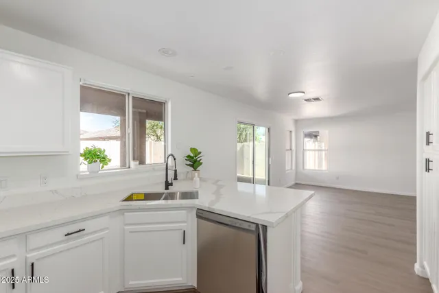 a kitchen with a sink cabinets and window