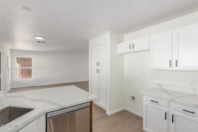 a kitchen with a sink stove and cabinets