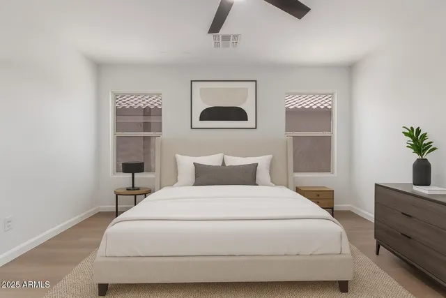 a bedroom with a bed and a potted plant