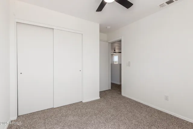 an empty room with ceiling fan