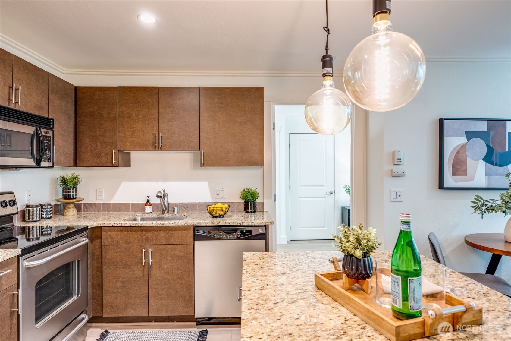 626 4th Avenue West, Unit 104 Seattle, WA 98119 - Photo 13 of 37 a kitchen with a sink a stove cabinets and chandelier