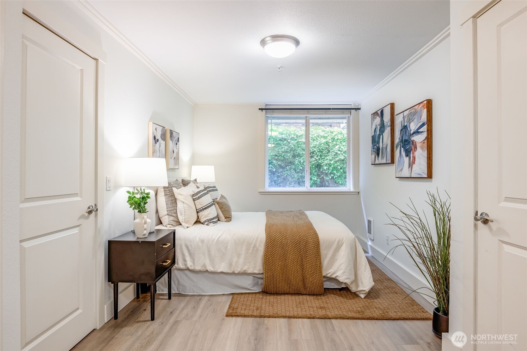 626 4th Avenue West, Unit 104 Seattle, WA 98119 - Photo 17 of 37 a bedroom with a bed and wooden floor
