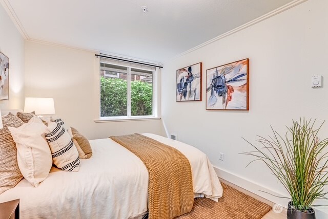 626 4th Avenue West, Unit 104 Seattle, WA 98119 - Photo 18 of 37 a bedroom with a bed and a painting on the wall