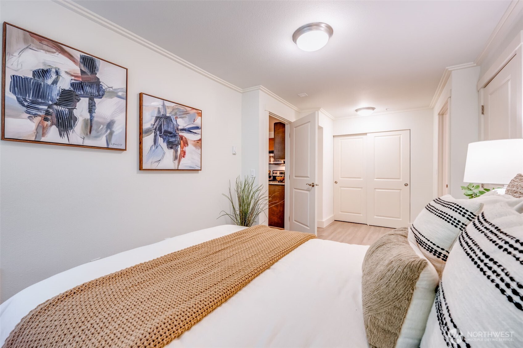 626 4th Avenue West, Unit 104 Seattle, WA 98119 - Photo 19 of 37 a bedroom with a large bed and a painting on the wall