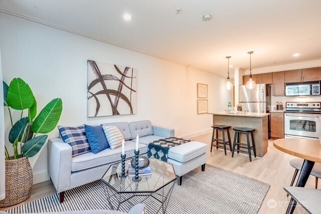 626 4th Avenue West, Unit 104 Seattle, WA 98119 - Photo 6 of 37 a living room with furniture kitchen view and a chandelier