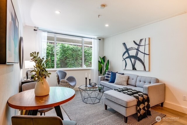 626 4th Avenue West, Unit 104 Seattle, WA 98119 - Photo 7 of 37 a living room with furniture and a large window