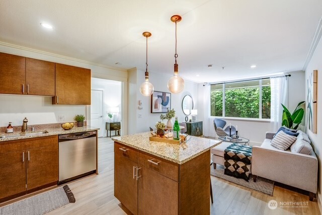 626 4th Avenue West, Unit 104 Seattle, WA 98119 - Photo 10 of 37 a kitchen with a sink a counter top space and living room view