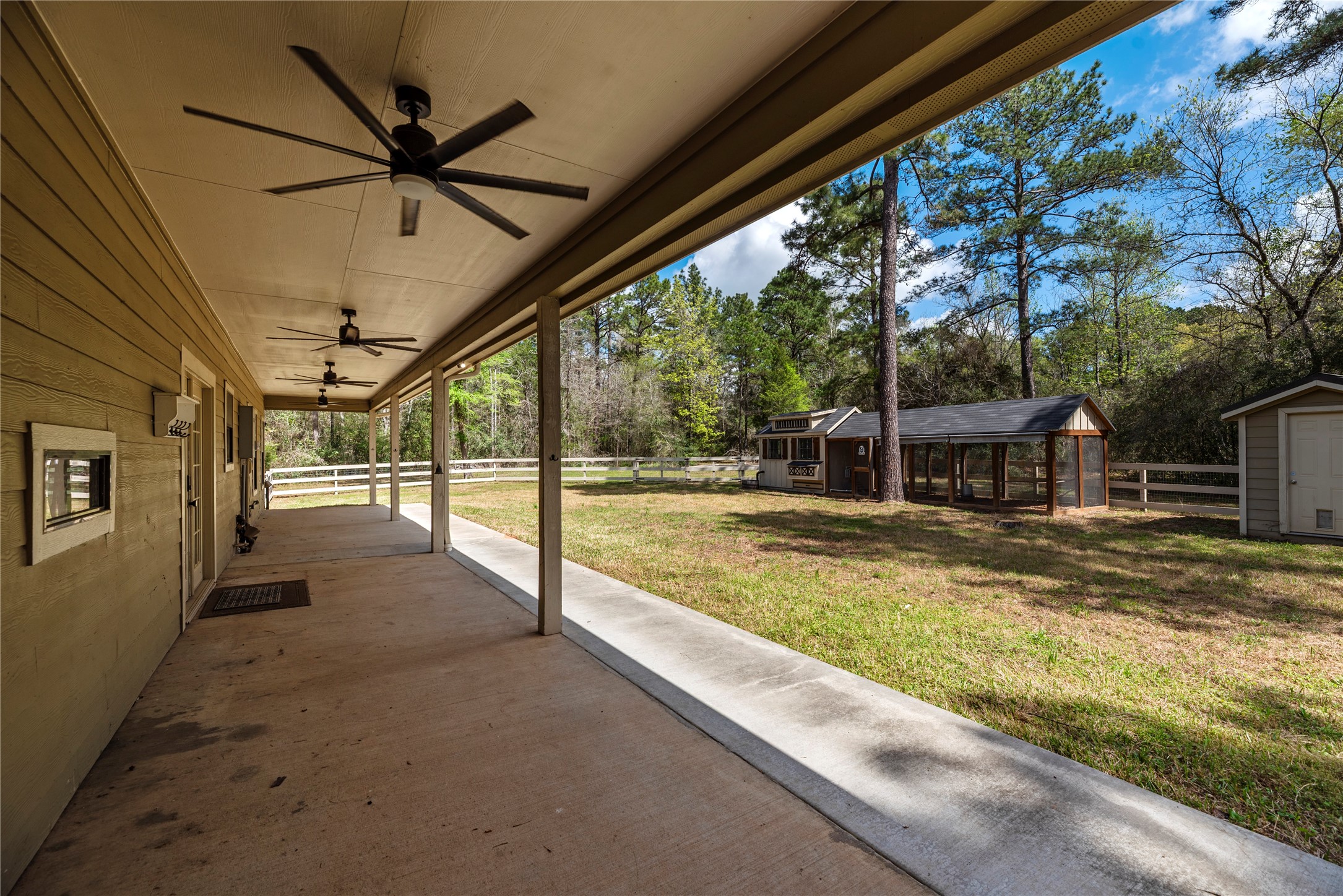 12062 Ike White Road Conroe, TX 77303 - Photo 29 of 37 Large, covered back patio with ceiling fans.