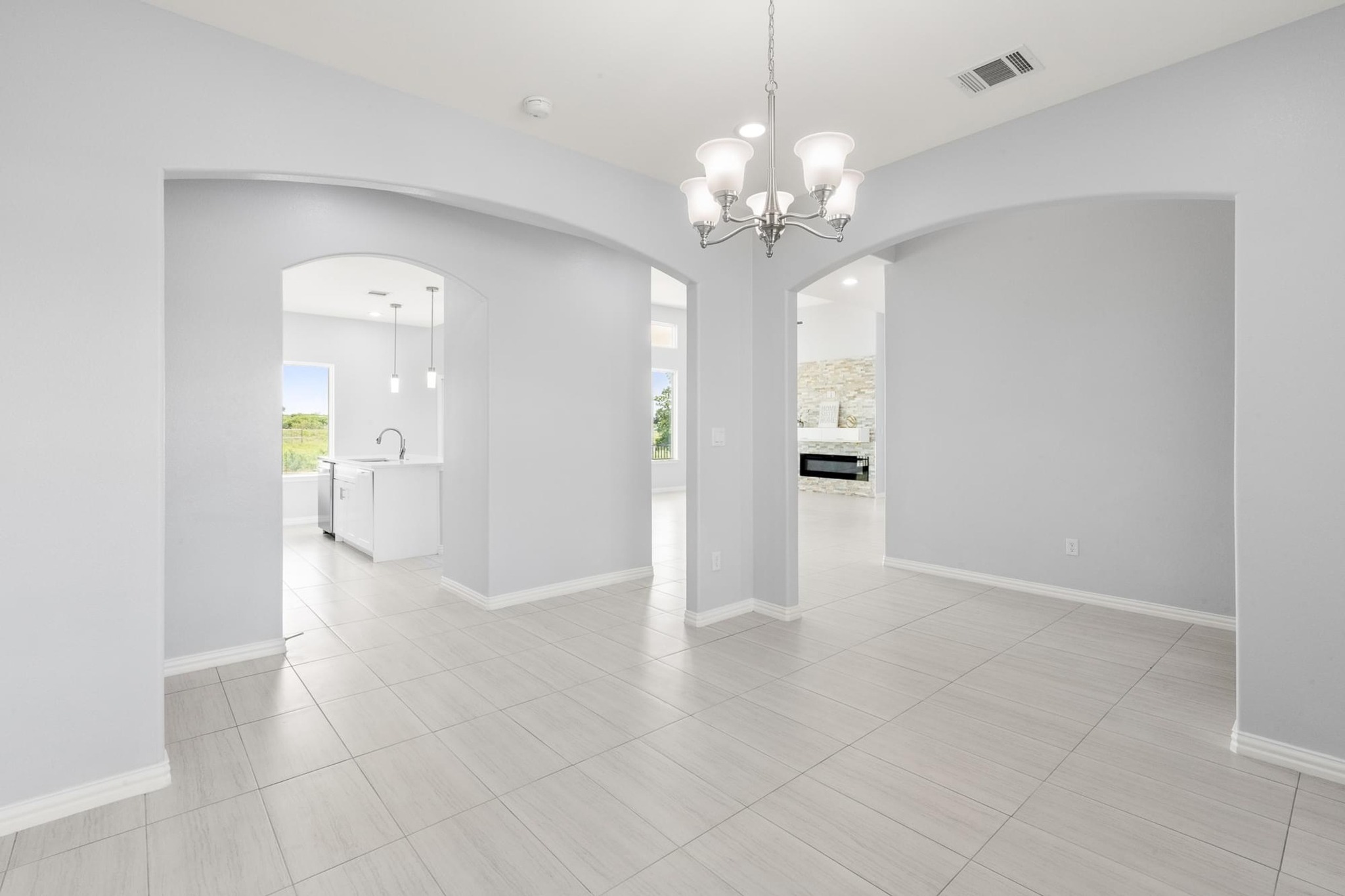 1136 County Road 484 Elgin, TX 78621 - Photo 6 of 37 Spare room featuring arched walkways and a chandelier