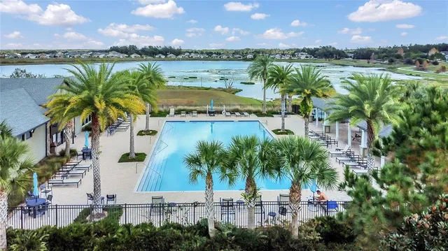 a view of a swimming pool and lake in the back