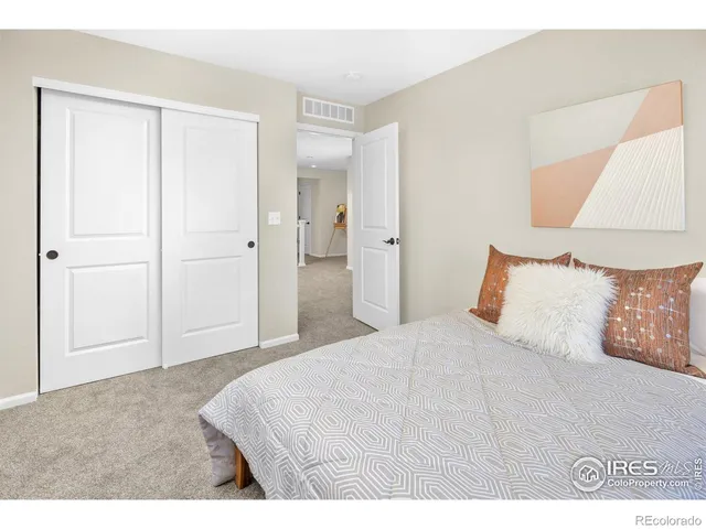 a bedroom with a bed and a night stand