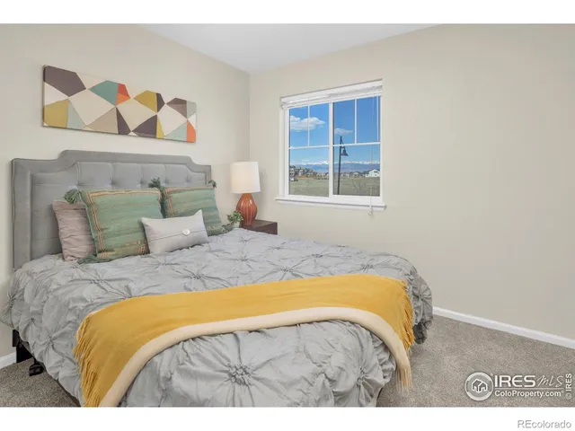 a bedroom with a bed and a painting on the wall