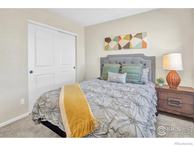 a bedroom with a bed and a lamp