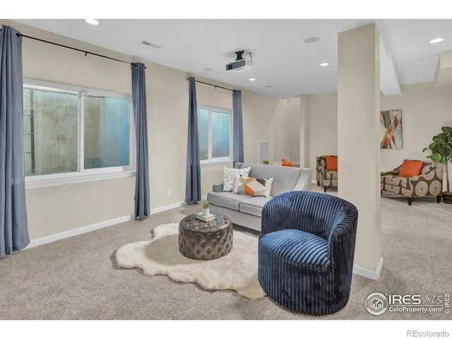 a living room with furniture a rug and a window