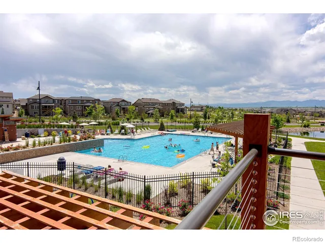 a front view of a house with a yard and potted plants