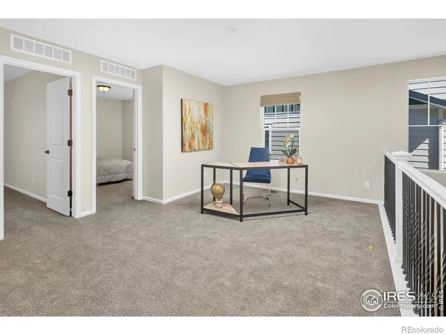 a view of a livingroom with furniture and staircase