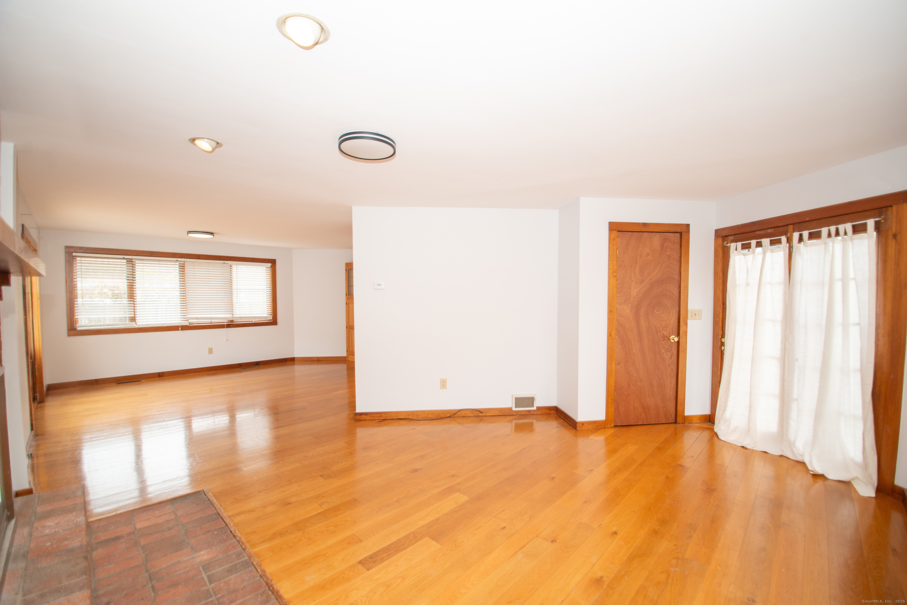 38 Wayland Road Milford, CT 06460 - Photo 11 of 39 an empty room with wooden floor and windows