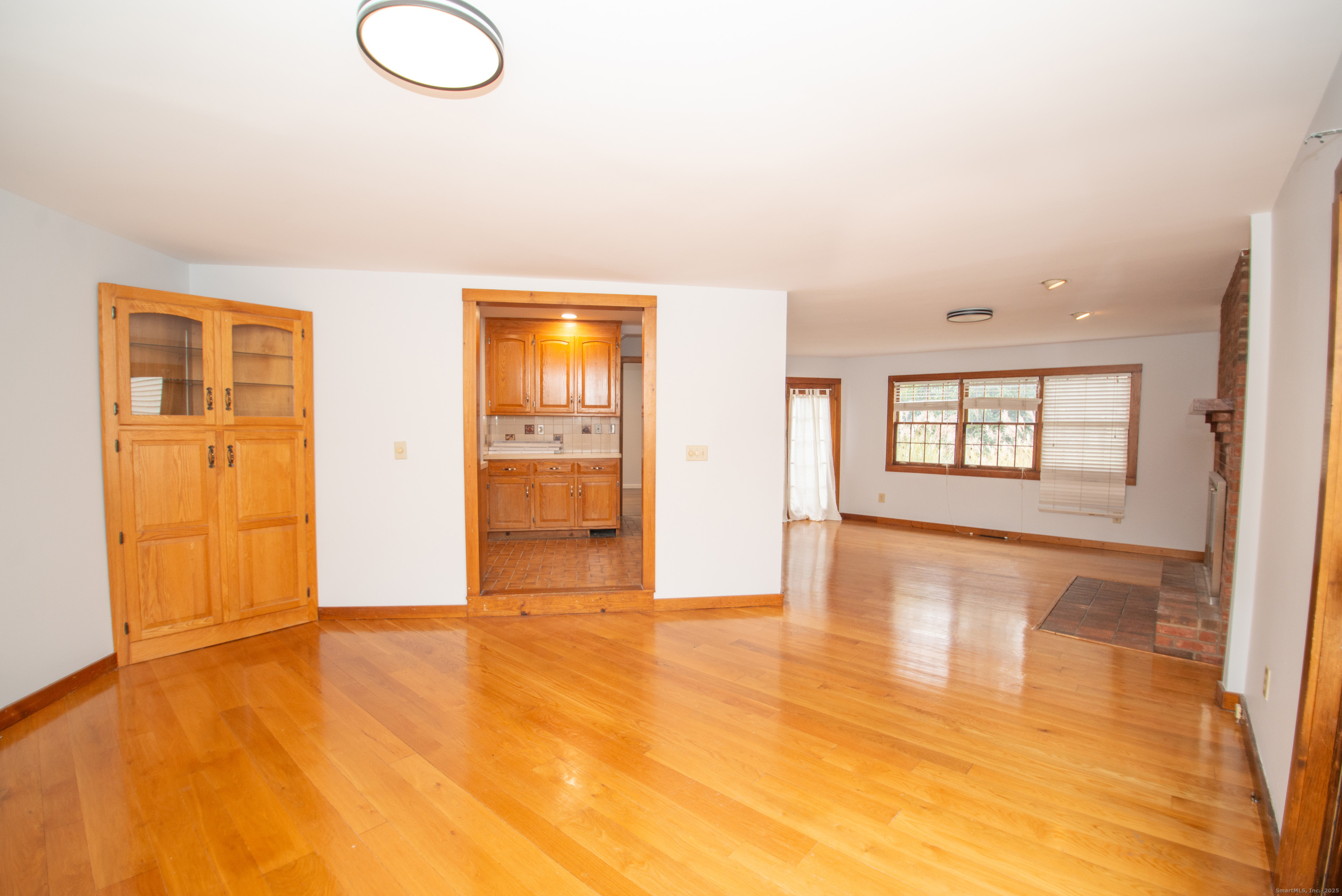 38 Wayland Road Milford, CT 06460 - Photo 16 of 39 a view of empty room with wooden floor and fan